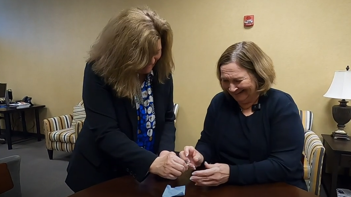 Mary Strand, right, is presented with her long-lost diamond ring.