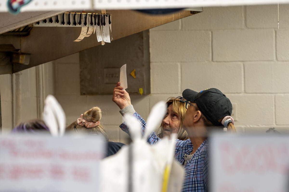 Associates look at ticket orders at Christy's Tasty Queen on Wednesday, Feb. 18, 2026, in Kansas City, Kansas. It is the restaurant's final day under its founding owners.