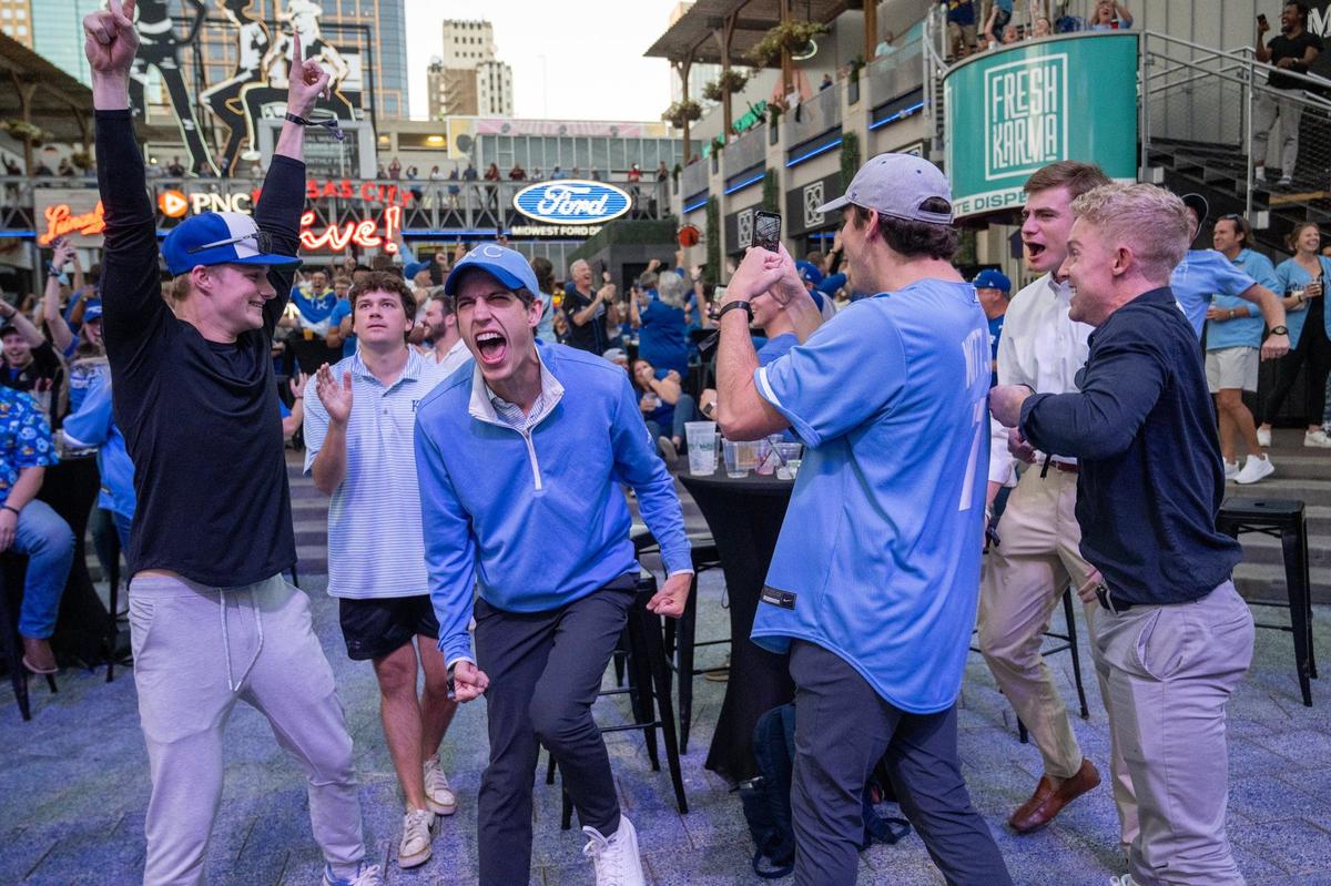Royals fans including Connor FitzGerald, center, of Kansas City, celebrates with friends at the Kansas City Power & Light District as the Royals defeated the Baltimore Orioles, 2-1, to win the Wild Card series in Baltimore on Wednesday, October 2, 2024. The Royals advance to the ALDS, where they will face the Yankees in New York on Saturday.