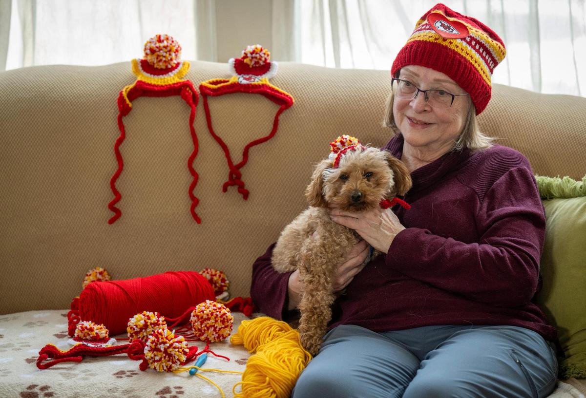 Jan Powell, with her dog Billy, crochets each Chiefs-themed hat she sells. Each hat takes about 3.5 hours to make.