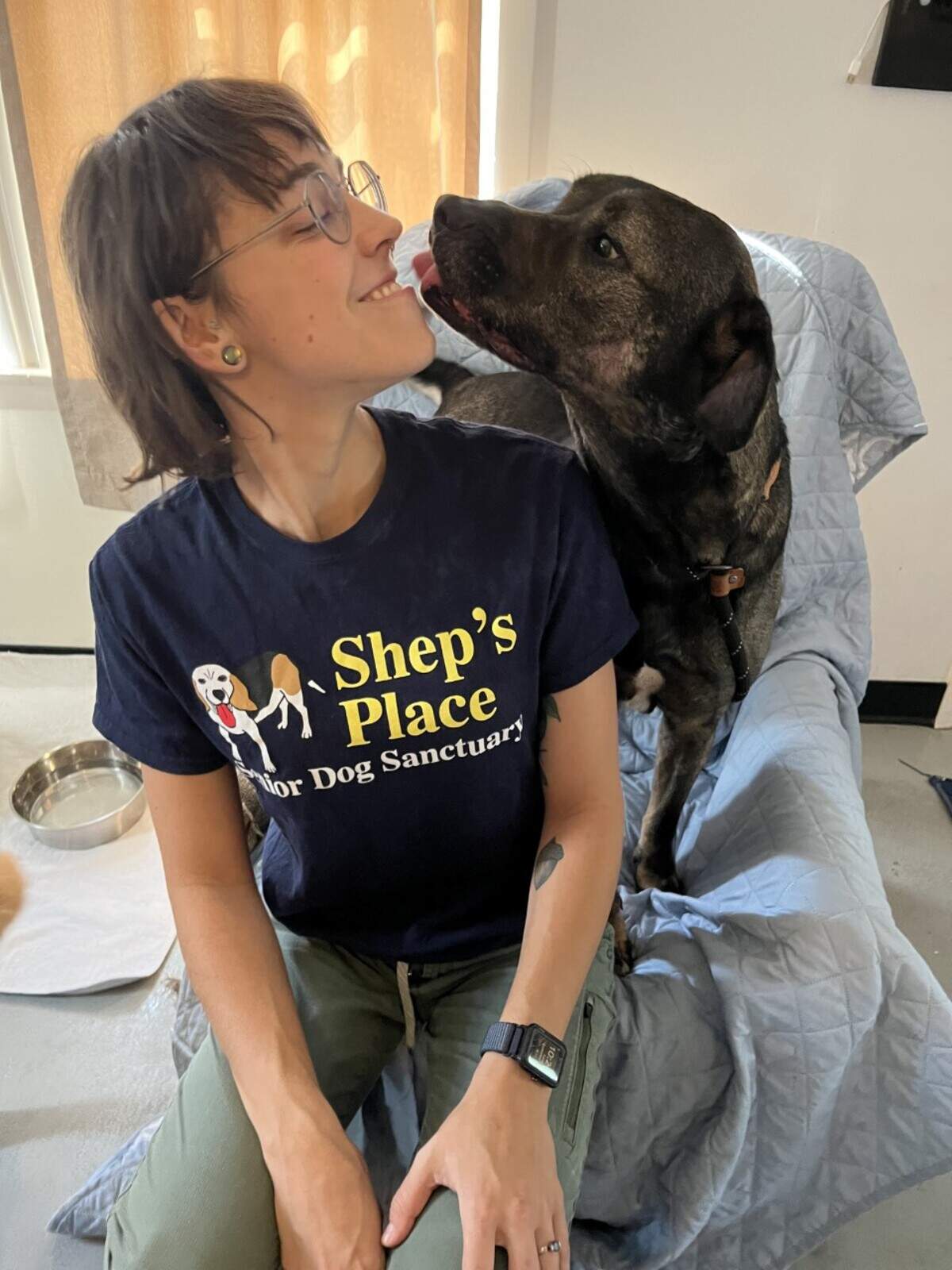 Lindsay Fletcher, the medical coordinator at Shep’s Place, give Hank a bit of love.