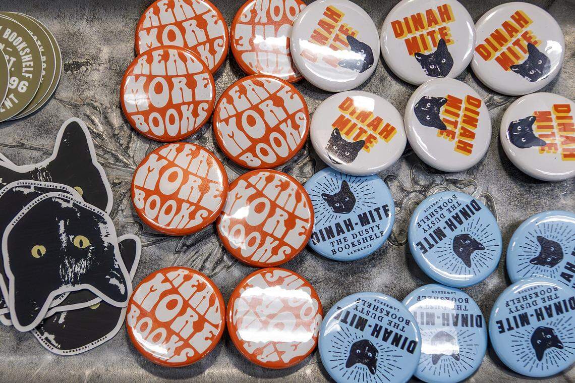 Pins and stickers featuring Dinah, a shop cat at The Dusty Bookshelf, are displayed for sale on Wednesday, Nov. 5, 2025, in Lawrence.