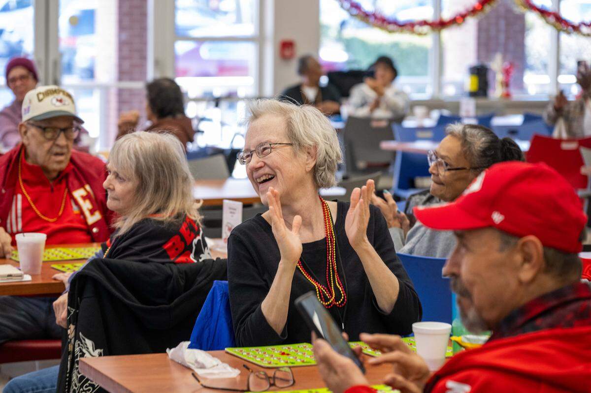 Sylva Patterson claps as former Chiefs players are introduced before a round of bingo at the Don Bosco Senior Center on Tuesday, December 30, 2025, in Kansas City.
