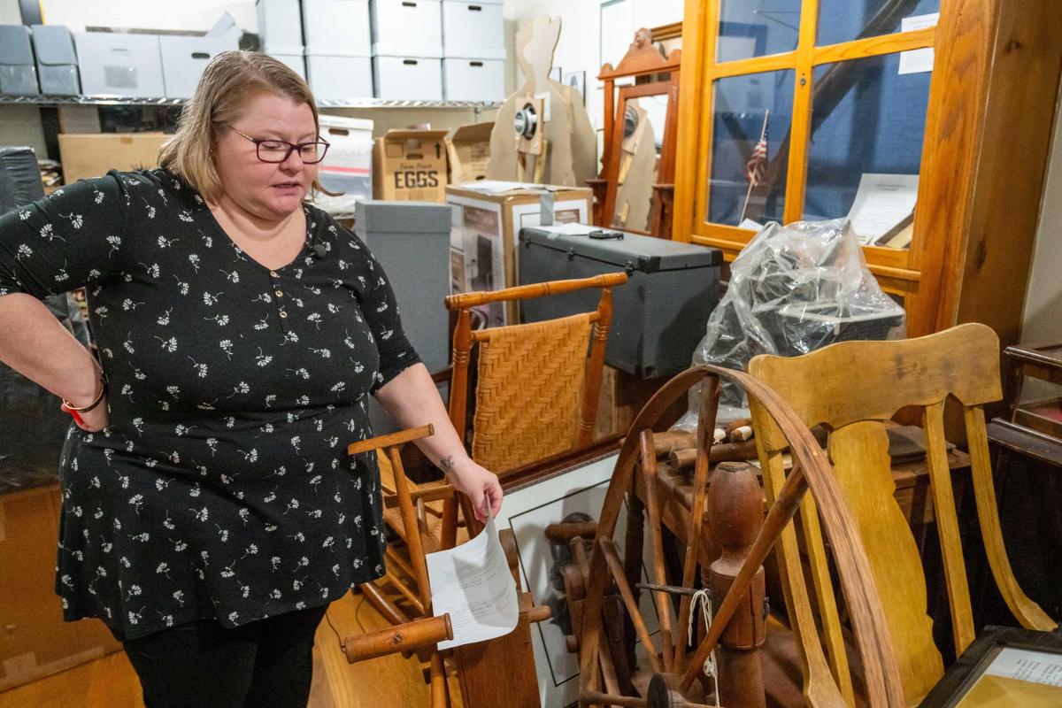 Cass County Historical Society director Jennifer Reed in looks over a recent donation of historical items ocated at the Cass County Public Library Harrisonville Branch on Thursday, Mar. 20, 2025. The archives recently lost their IMLS, Institute of Museum and Library Services, grant due to budget cuts by the Trump administration. Reed, its sole full-time employee, relies on the grants to pay interns to help sort through the relatively large amount of donations to the archives.
