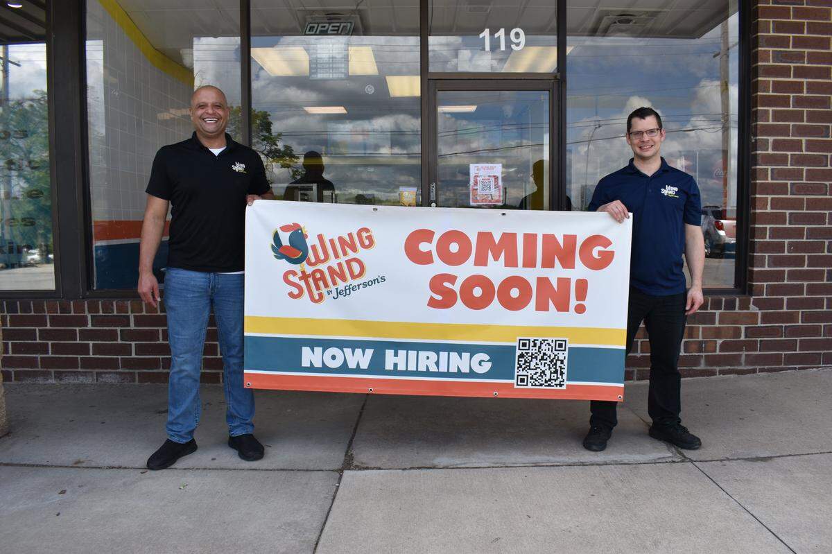 Joe Finch, right, owner and operator of the new WingStand in Olathe, poses with Michael Brown, the company’s director of operations.