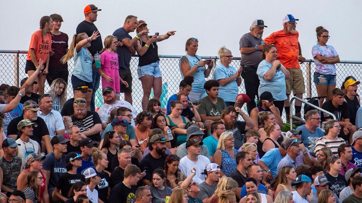 Fans react as cars crash into each other during the Demolition Derby at the Platte County Fair, Thursday, July 22, 2021, in Tracy, Mo