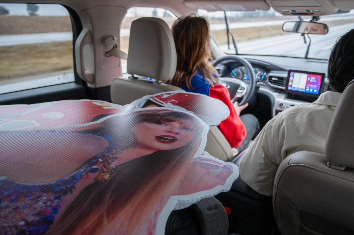 A cutout of pop star Taylor Swift is seen in the backseat as Kansas City Star journalists Alison Booth, Emily Curiel, and Irvin Zhang travel across Kansas on Sunday, Feb. 4, 2024, en route to Super Bowl LVIII in Las Vegas.