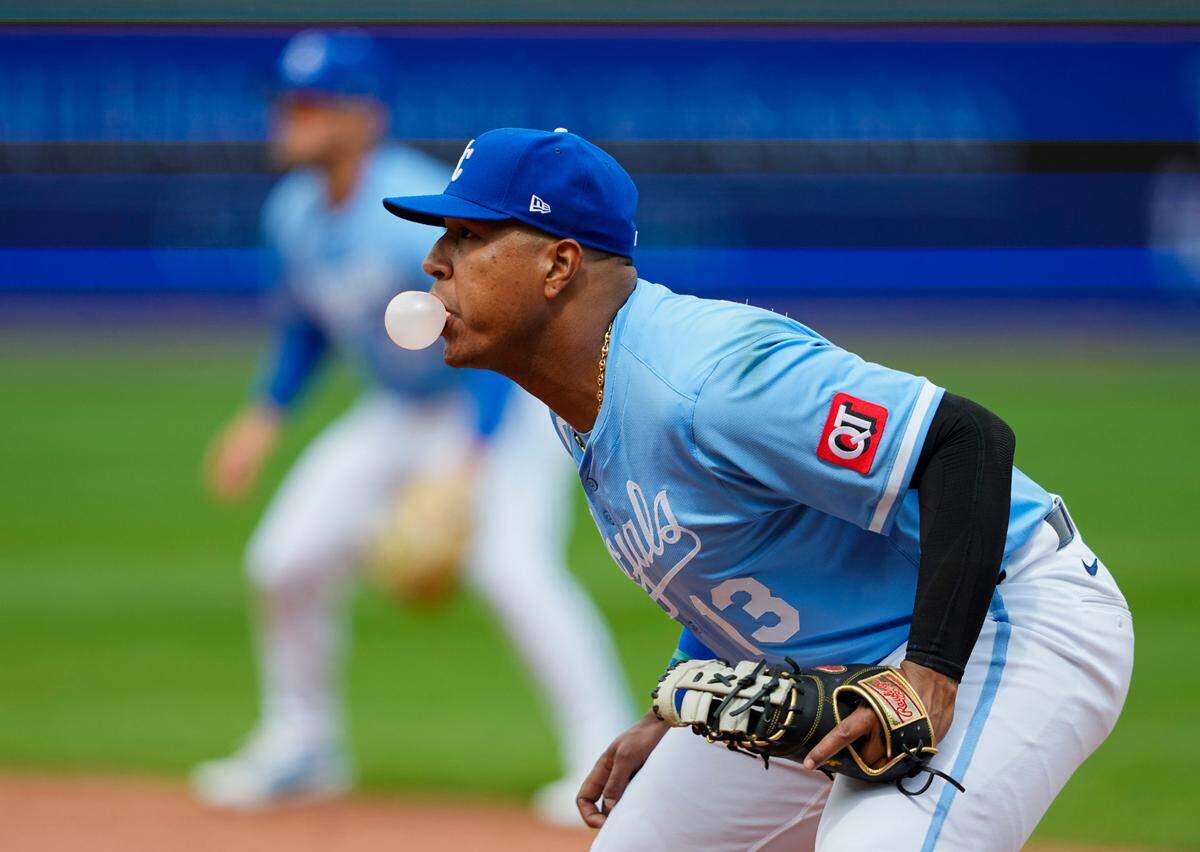 Kansas City Royals first baseman Salvador Perez blows a bubble while playing first base during a game against the Cleveland Guardians at Kauffman Stadium on Sunday, March 30, 2025.