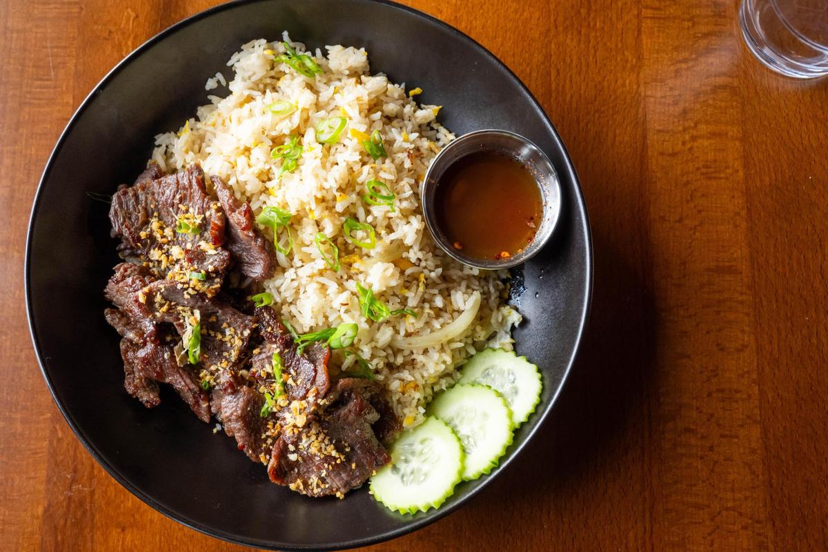 The Crying Tiger Garlic Fried Rice, a dish featuring marinated beef on top of garlic fried rice, is on the menu at the newest Thai Orchid location in Kansas City.