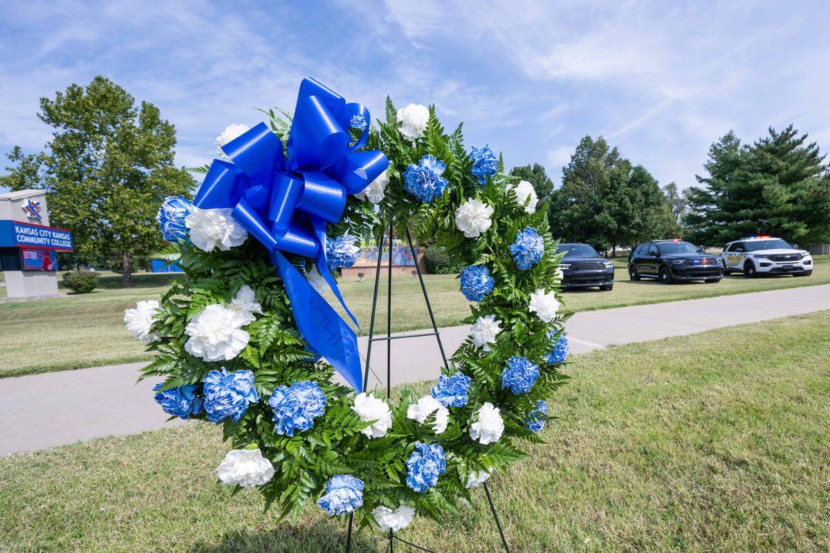A memorial wreath is set up near the place where slain KCKPD Officer Hunter Simoncic was injured, on Wednesday, Sept. 3, 2025, in Kansas City, Kansas. Simoncic was killed Aug. 26 after being struck by a fleeing driver while deploying stop sticks.