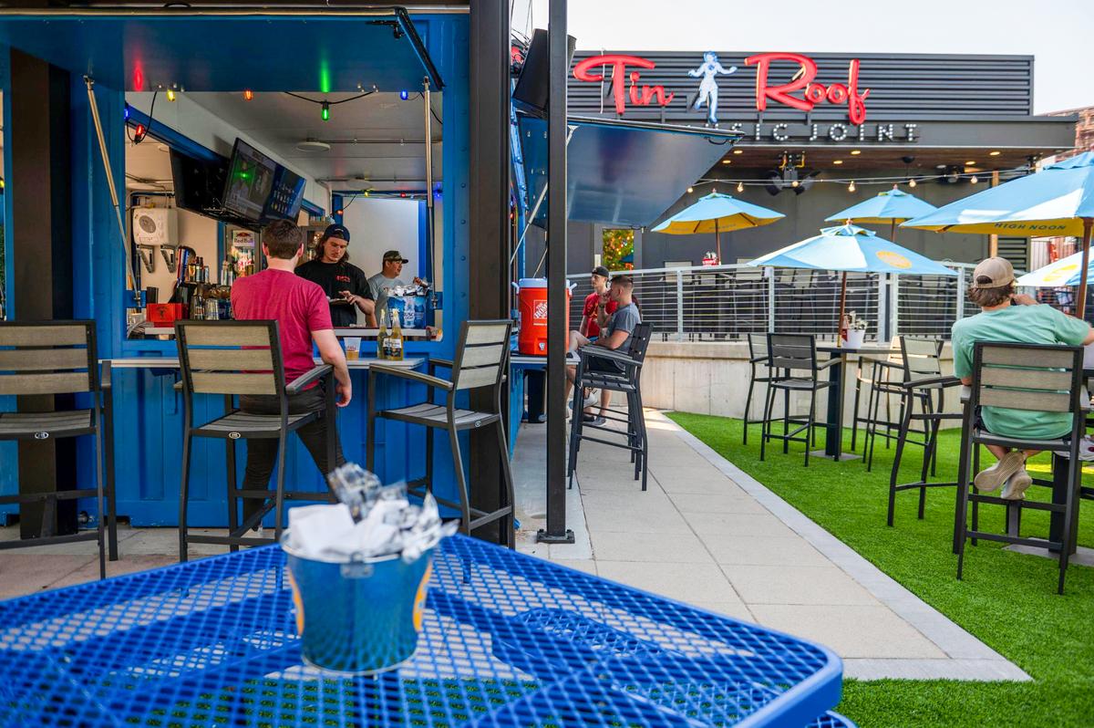 Tin Roof provides picnic tables and a patio seating area outside.