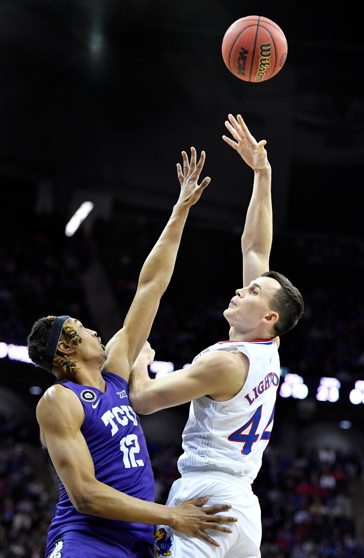 KU’s Mitch Lightfoot shoots over TCU’s Xavier Cork during the first half of Friday’s semifinal game at the Big 12 Conference Tournament in Kansas City.