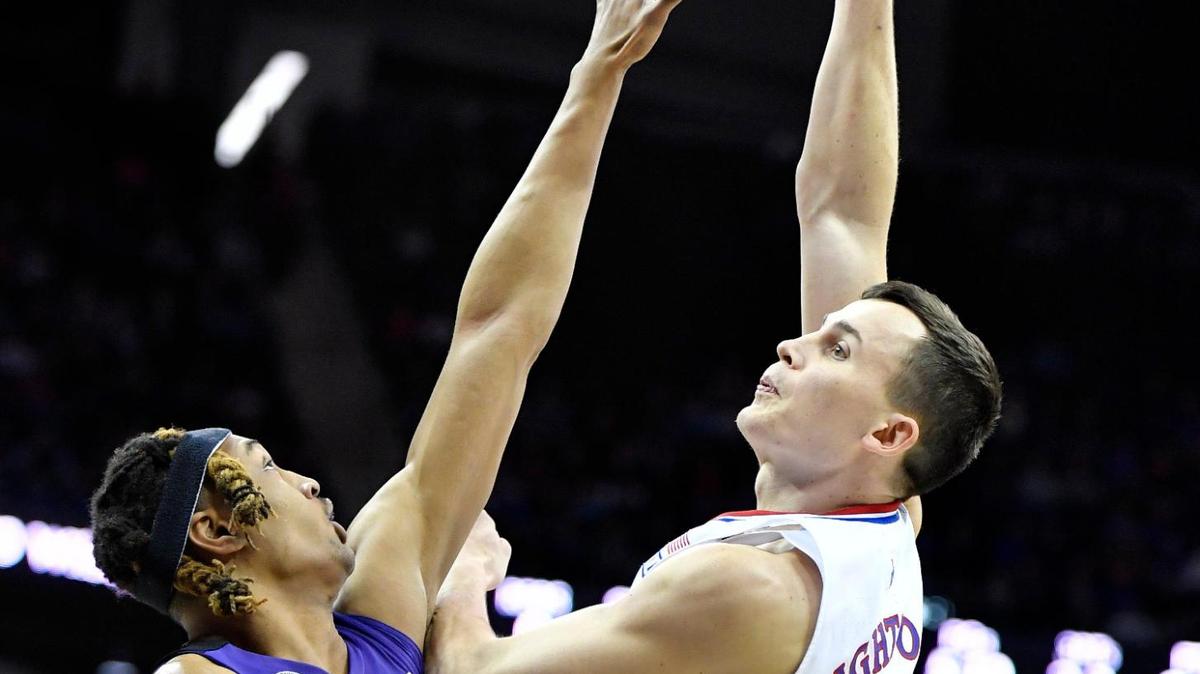 KU’s Mitch Lightfoot shoots over TCU’s Xavier Cork during the first half of Friday’s semifinal game at the Big 12 Conference Tournament in Kansas City.