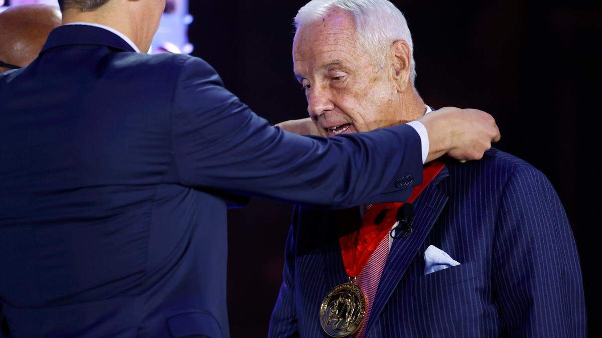 Former Kansas coach Roy Williams receives a medal during a National Collegiate Basketball Hall of Fame induction event on Nov. 20, 2022, in Kansas City, Mo.