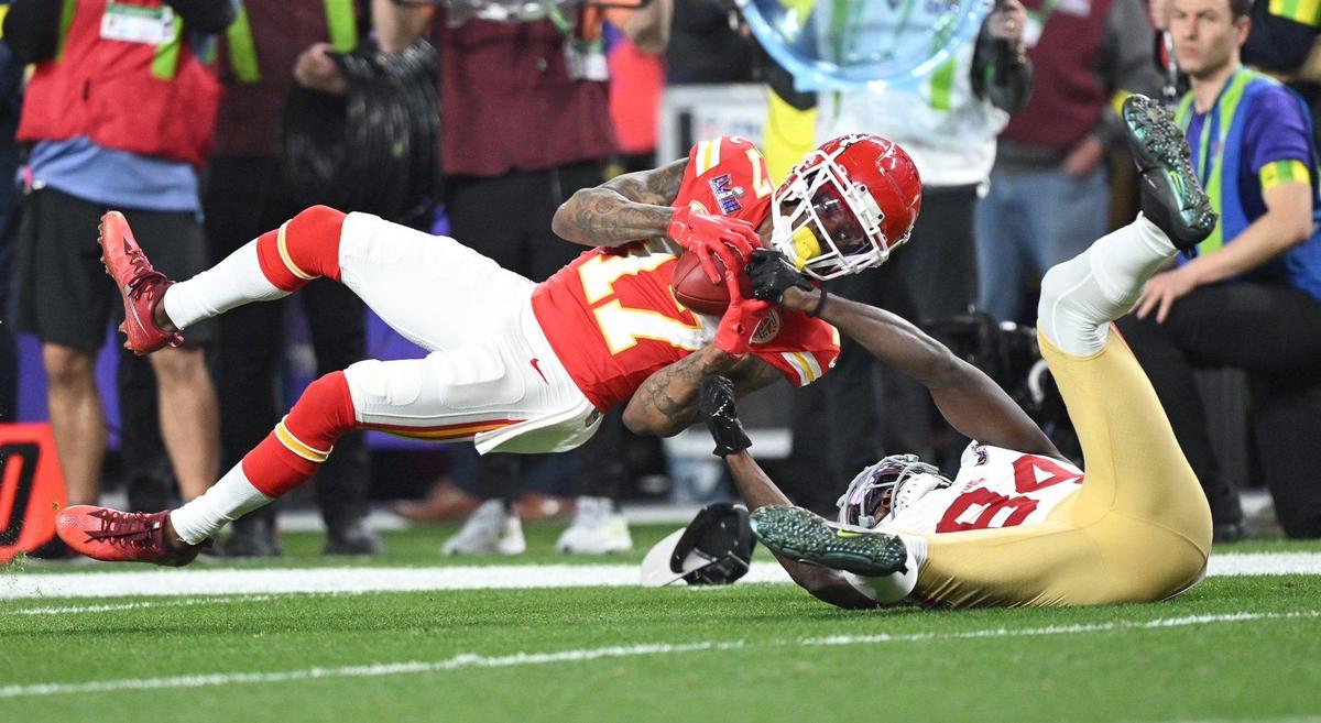 Kansas City Chiefs wide receiver Richie James (17) is jerked down by San Francisco 49ers wide receiver Chris Conley (84) after making a catch in the third quarter of Super Bowl LVIII, Sunday, Feb. 11, 2024, in Las Vegas.
