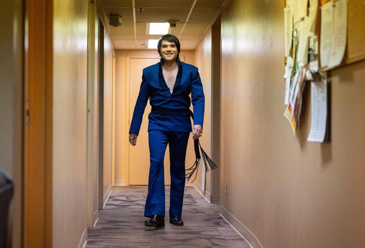 In costume for the first set, Trevino grins as he walks out of his dressing room and heads toward the stage for his starring role.