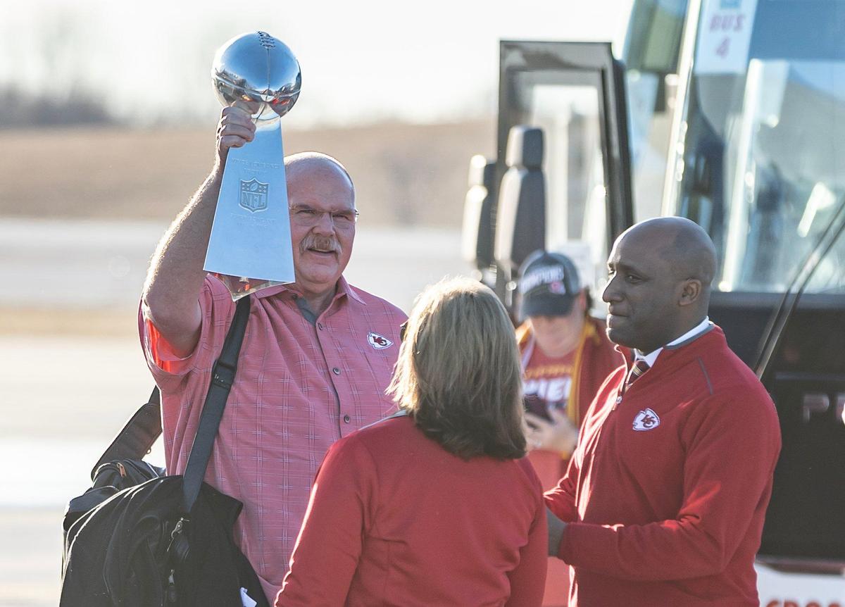 Chiefs’ head coach Andy Reid holds up the Vince Lombardi trophy after stepping off a charter flight at Kansas City International Airport on Monday. The Kansas City Chiefs returned home after defeating the Philadelphia Eagles in Super Bowl LVII in Glendale, Ariz.