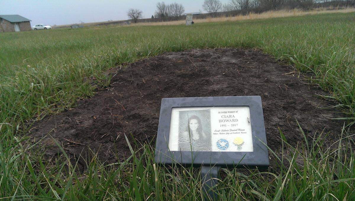 Ciara Howard of Olathe was buried in the tiny Mount Hope Cemetery outside of Williamsburg in a barren grave, her family unable to provide a headstone, her place marked by a small metal-framed sign barely larger than an index card. She was shot by police in August.