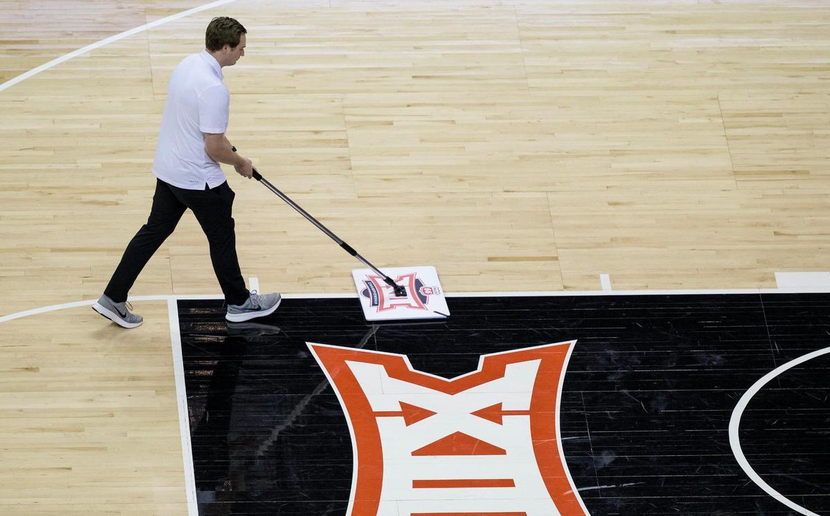 While most of the people who make the Big 12 tournament run are behind the scenes, the court sweepers can’t be shy about doing their work in front of a crowd. On Wednesday, a court sweeper sweeps sweat from the court during a second round game between Oklahoma and TCU at T-Mobile Center.