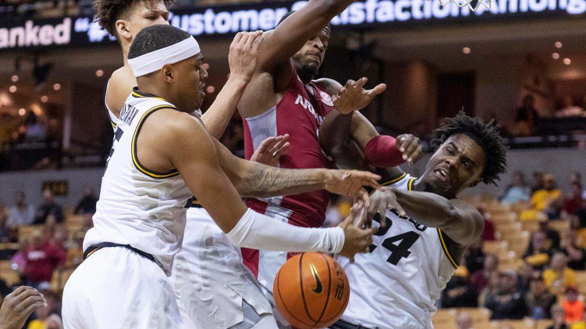 Arkansas’ Trey Wade (center) foights for a rebound against Missouri’s Kobe Brown (right), Jarron Coleman (left) and Trevon Brazile during the first half on Tuesday, Feb. 15, 2022, in Columbia, Mo. (AP Photo/L.G. Patterson)