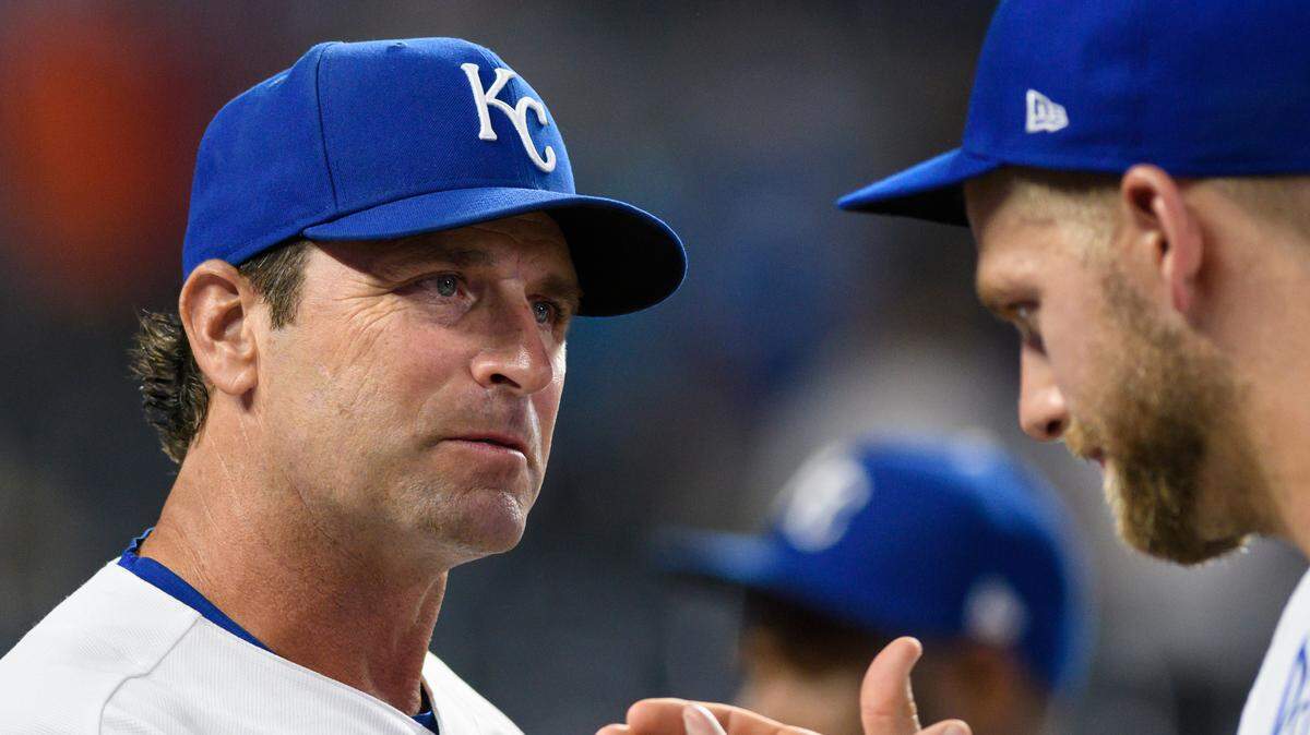 Kansas City Royals manager Mike Matheny (left) congratulates Hunter Dozier after the team’s 3-2 win over the Houston Astros , Aug. 18, 2021, in Kansas City, Mo.