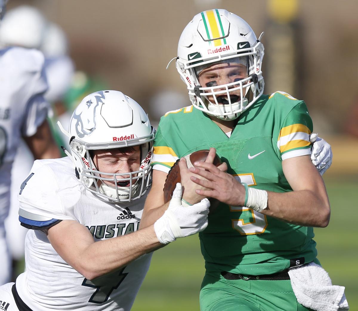 Blue Valley North defender #4 Cameron Burt  tries strip the ball from  Derby quarterback Hunter  Igo on a long run int the 3rd quarter.  (November 24, 2018)