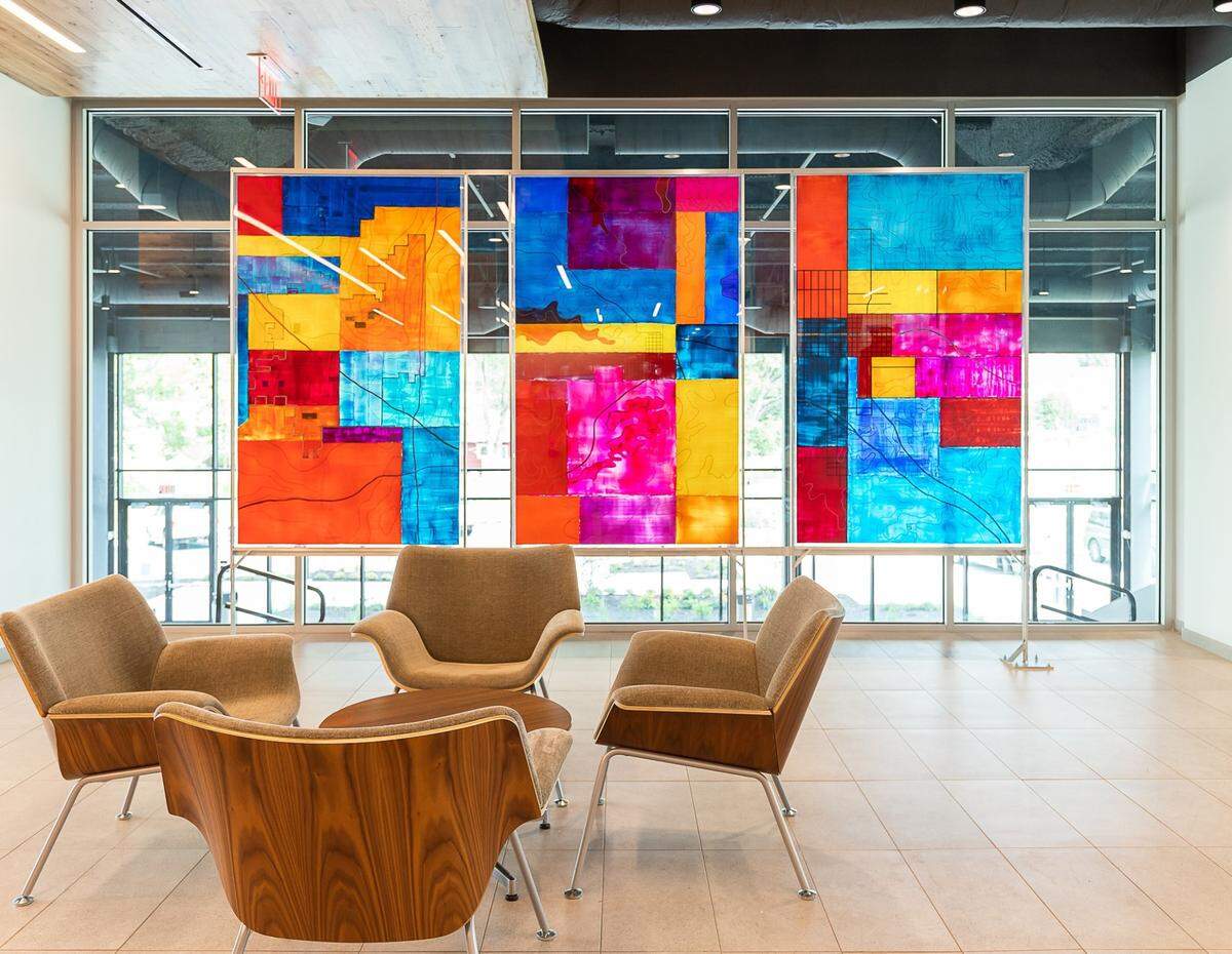 These panels, acrylic paint on plexiglass, by MJ Rigbyd epict the city of Olathe  in 1890, 1960 and 2020.