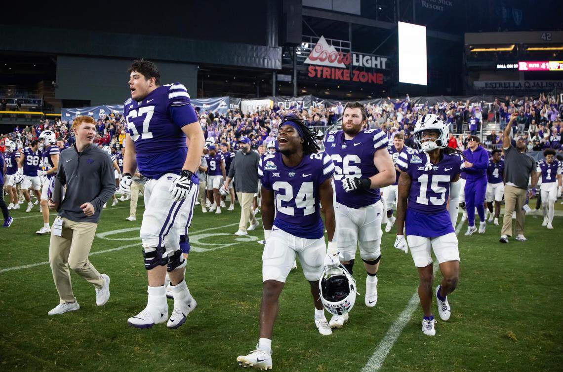 Kansas State Wildcats offensive lineman Logan Cox (67) celebrates with running back JB Price (24) and wide receiver Trae Davis (15) after defeating the Rutgers Scarlet Knights during the Rate Bowl at Chase Field on Dec. 26, 2024.