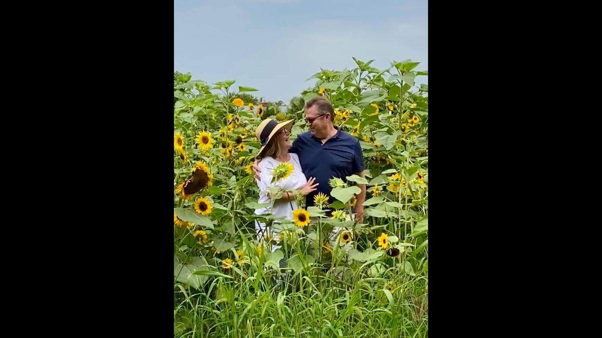 Julie and Wes Rains share a moment in a mass of color. This year’s Sunflower Festival will be held on weekends beginning Aug. 9.