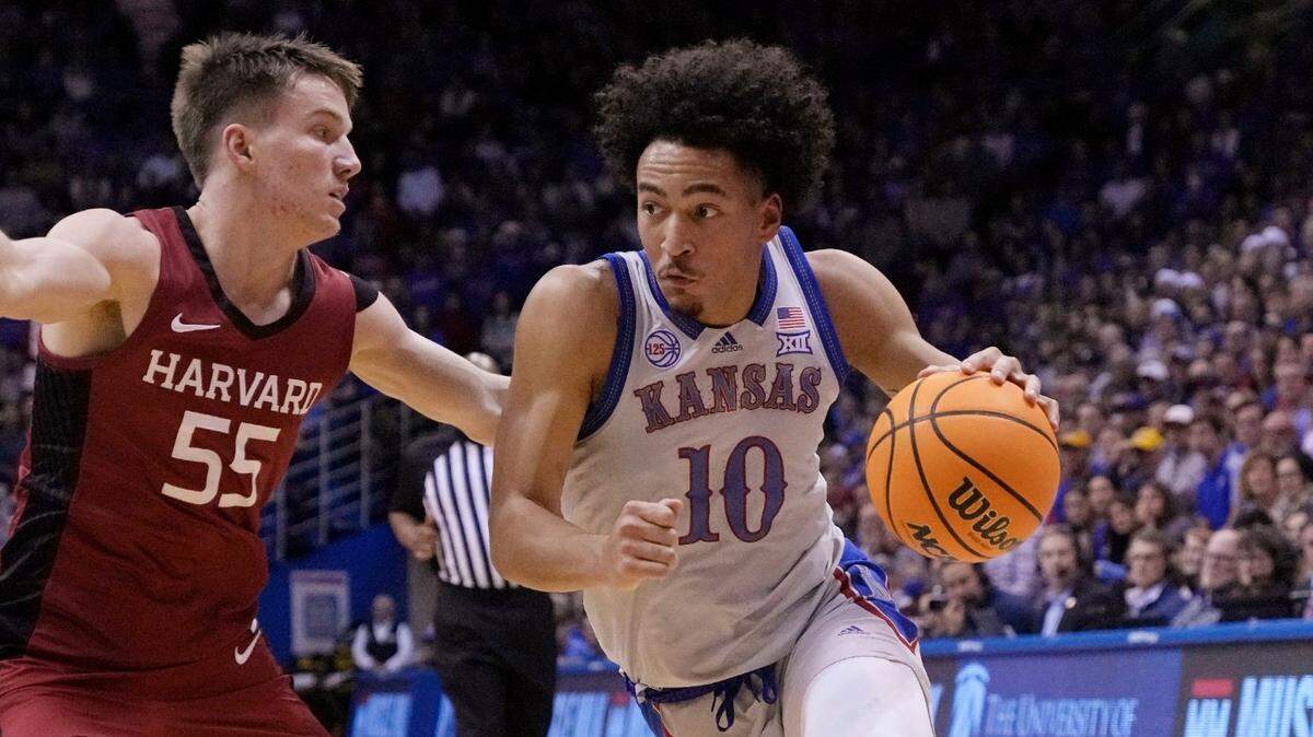 Kansas forward Jalen Wilson (10) drives on Harvard guard Denham Wojcik (55) during the first half on Thursday, Dec. 22, 2022, in Lawrence, Kan. Kansas won 68-54.