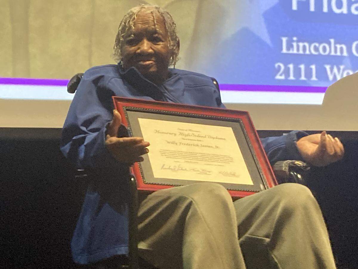 Elizabeth Baldwin, 104-year-old sister of the late Pfc. Willy F. James, Jr., recipient of the Medal of Honor, received her brother’s honorary high school diploma from Lincoln College Preparatory Academy.