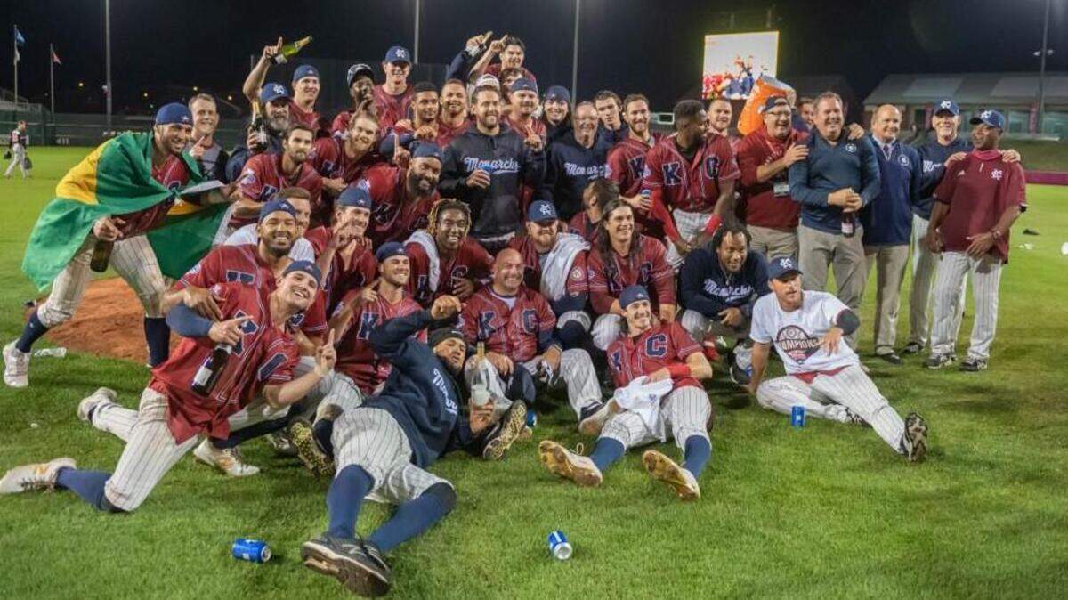 Players, coaches and support staff pose for a post-game photo as the Kansas City Monarchs celebrate the third championship in club history Monday night at Legends Field in Kansas City, Kan.
