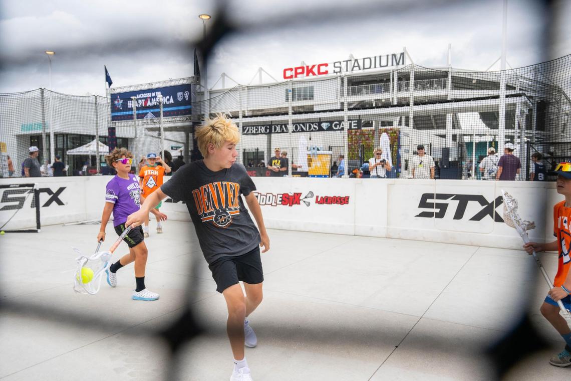 Young fans of lacrosse playing on a small court in front of CPKC Stadium ahead of the PLL All-Star game in Kansas City on Saturday, July 5, 2025.