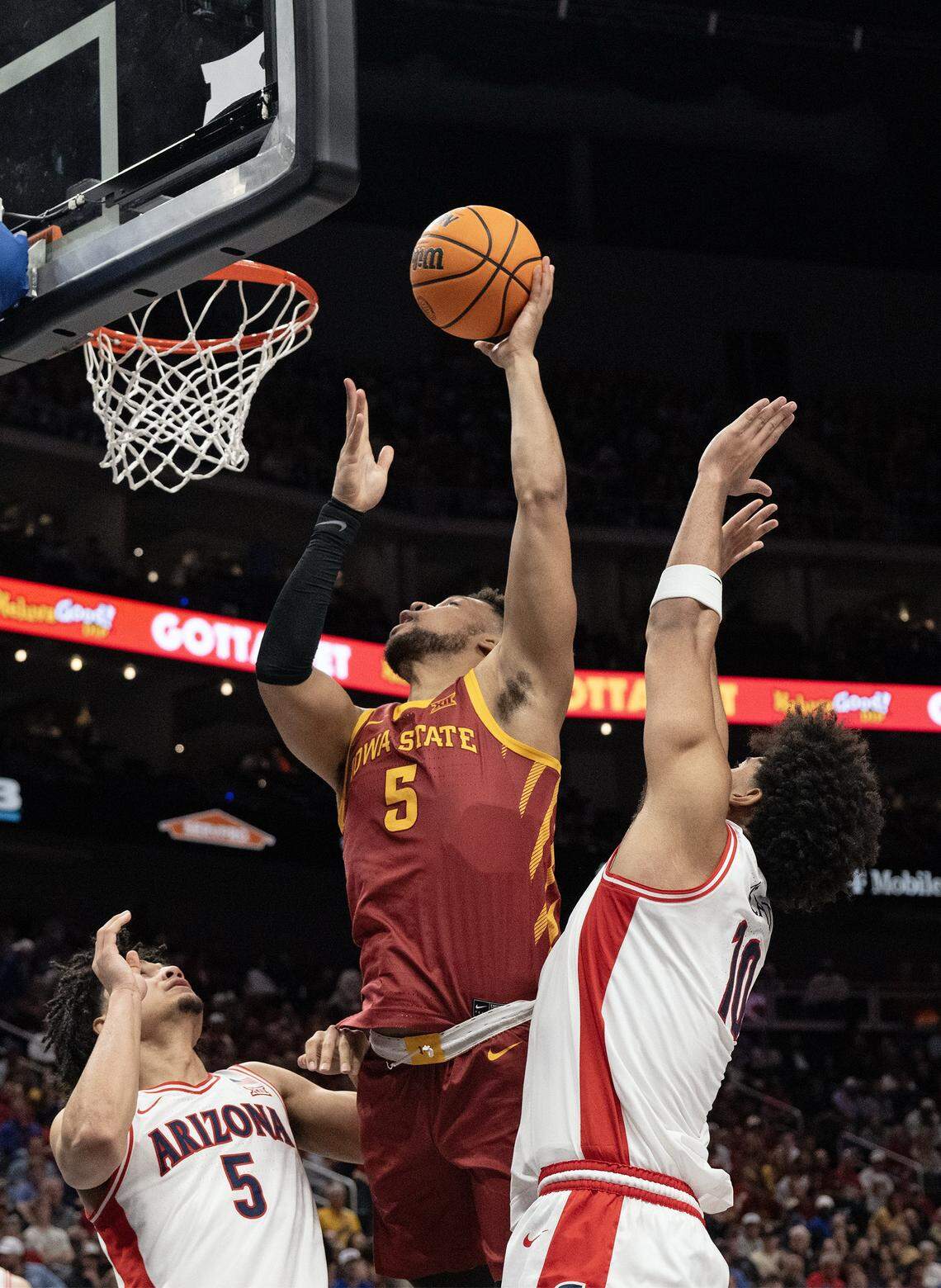 Iowa State Cyclones forward Joshua Jefferson (5) shoots as Arizona Wildcats guard Brayden Burries (5) and forward Koa Peat (10) defend during a semifinal game at the Big 12 Men’s Basketball Tournament inside Kansas City’s T-Mobile Center on Friday, March 13, 2026.