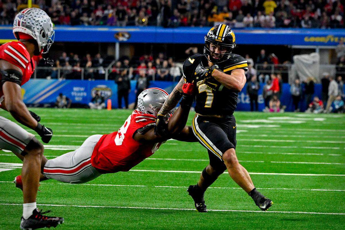 Missouri Tigers running back Cody Schrader picks up a first down against the Ohio State Buckeyes during Friday’s Cotton Bowl at AT&T Stadium. 