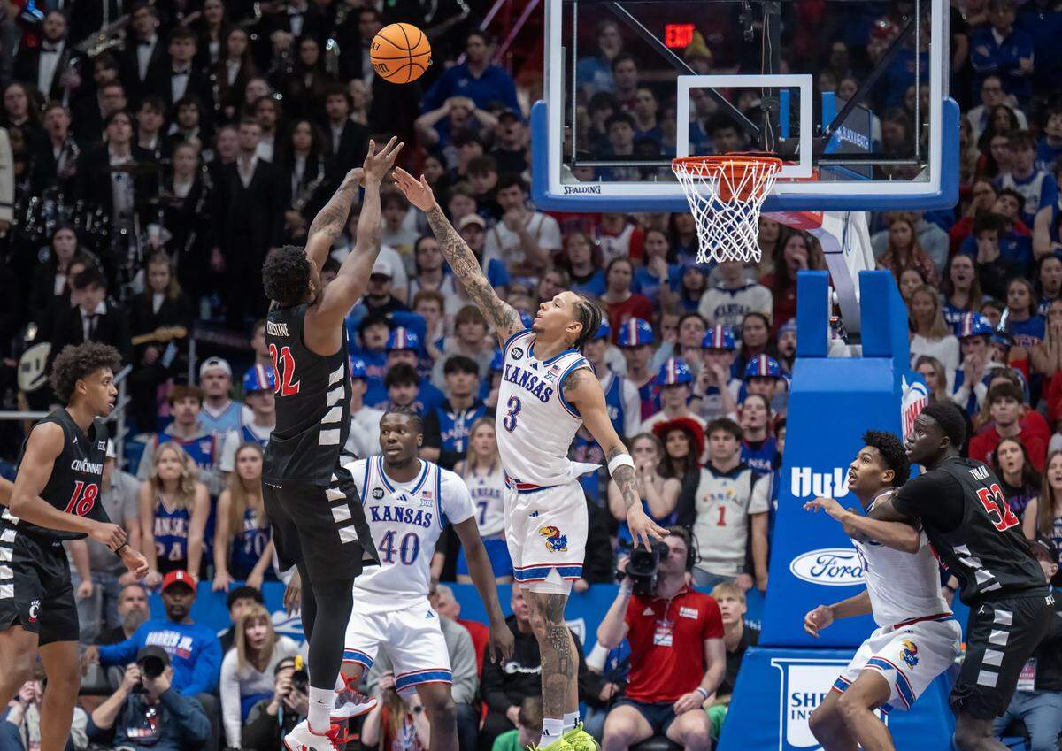 Kansas Jayhawks guard Tre White (3) blocks as Cincinnati Bearcats forward Jalen Celestine (32) shoots in the second half Allen Fieldhouse on Saturday, Feb. 21, 2026, in Lawrence, Kansas.