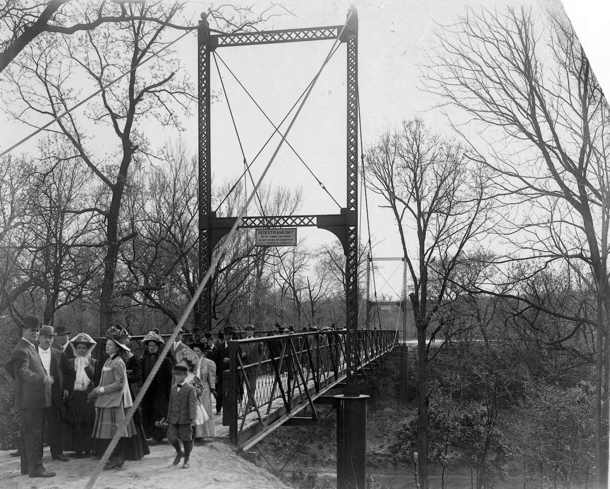 A crowd assembled at the Swinging Bridge near the time of its completion, circa 1907.