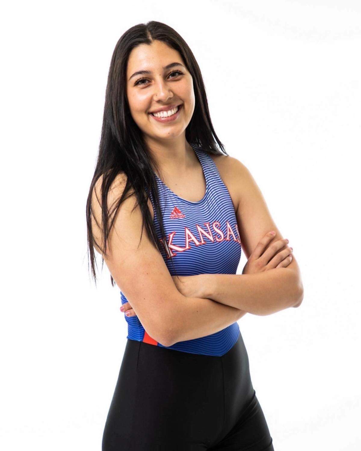 Isabela “Izzy” Estes poses for her freshman year media day portrait in her Kansas rowing uniform in the Fall of 2021.