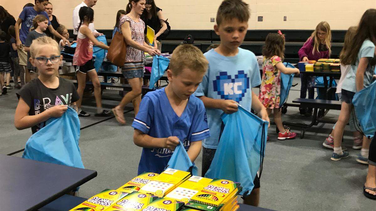 McKenna Lee, a first-grader at Morse Elementary School, Cooper Velleca, a first-grader at Green Springs Elementary, and Aidan Brannen, a third-grader at Sunnyside Elementary School, assemble care packages filled with art supplies.