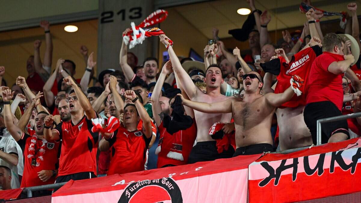 Austria fans react to their team getting their first goal in the first half of the World Cup game between Algeria and Austria at Kansas City (Arrowhead) Stadium on Saturday, June 27, 2026.