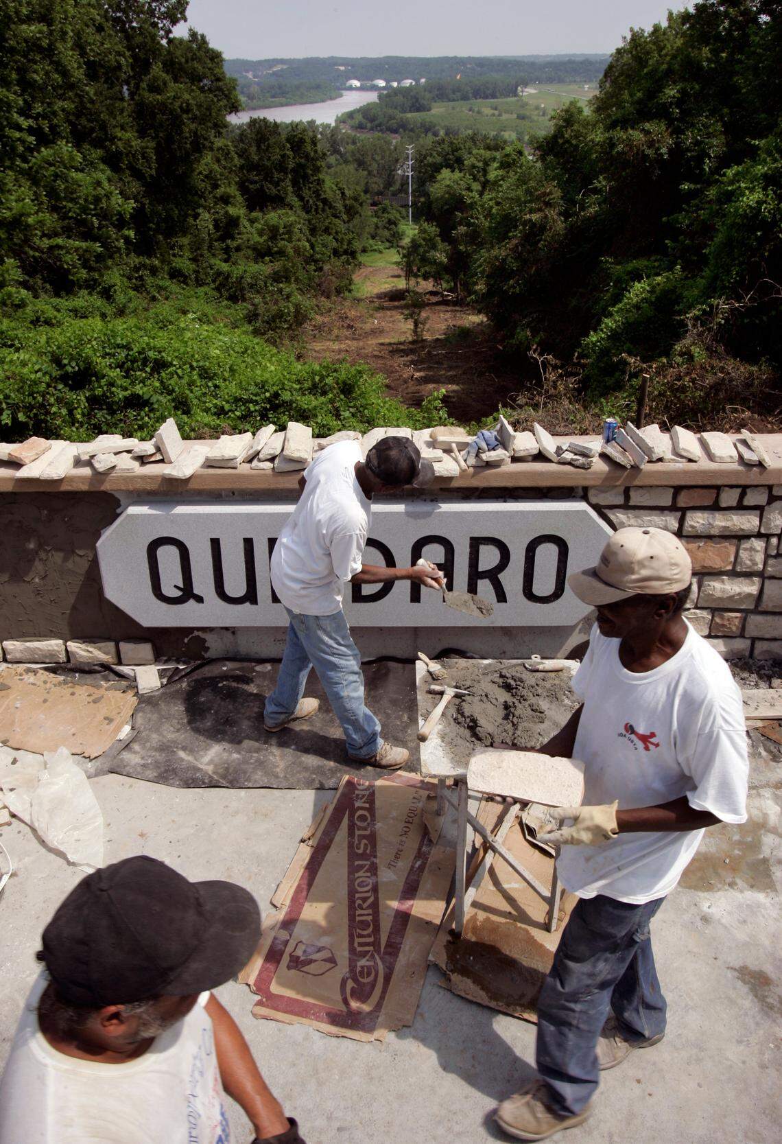 Donald Wilson (lower left), Eddie Jackson (center) and Robert Williams finished stonework on the Quindaro ruins overlook on Wednesday, June 25, 2008, at the north end of N. 27th Street in Kansas City, Kan. The Missouri River can be seen off in the distance.