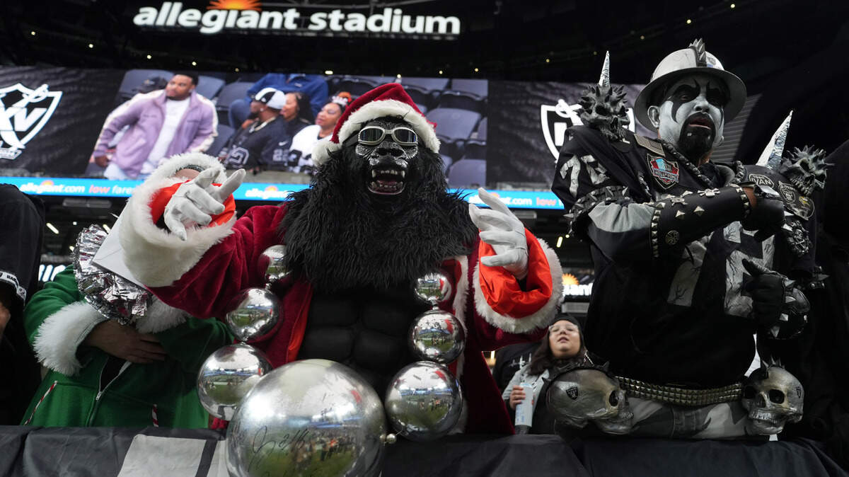 Dec 22, 2024; Paradise, Nevada, USA; Las Vegas Raiders fans Mark Acasio aka Gorilla Rilla (left) poses in Christmas costumes during the game against the Jacksonville Jaguars at Allegiant Stadium. Mandatory Credit: Kirby Lee-Imagn Images