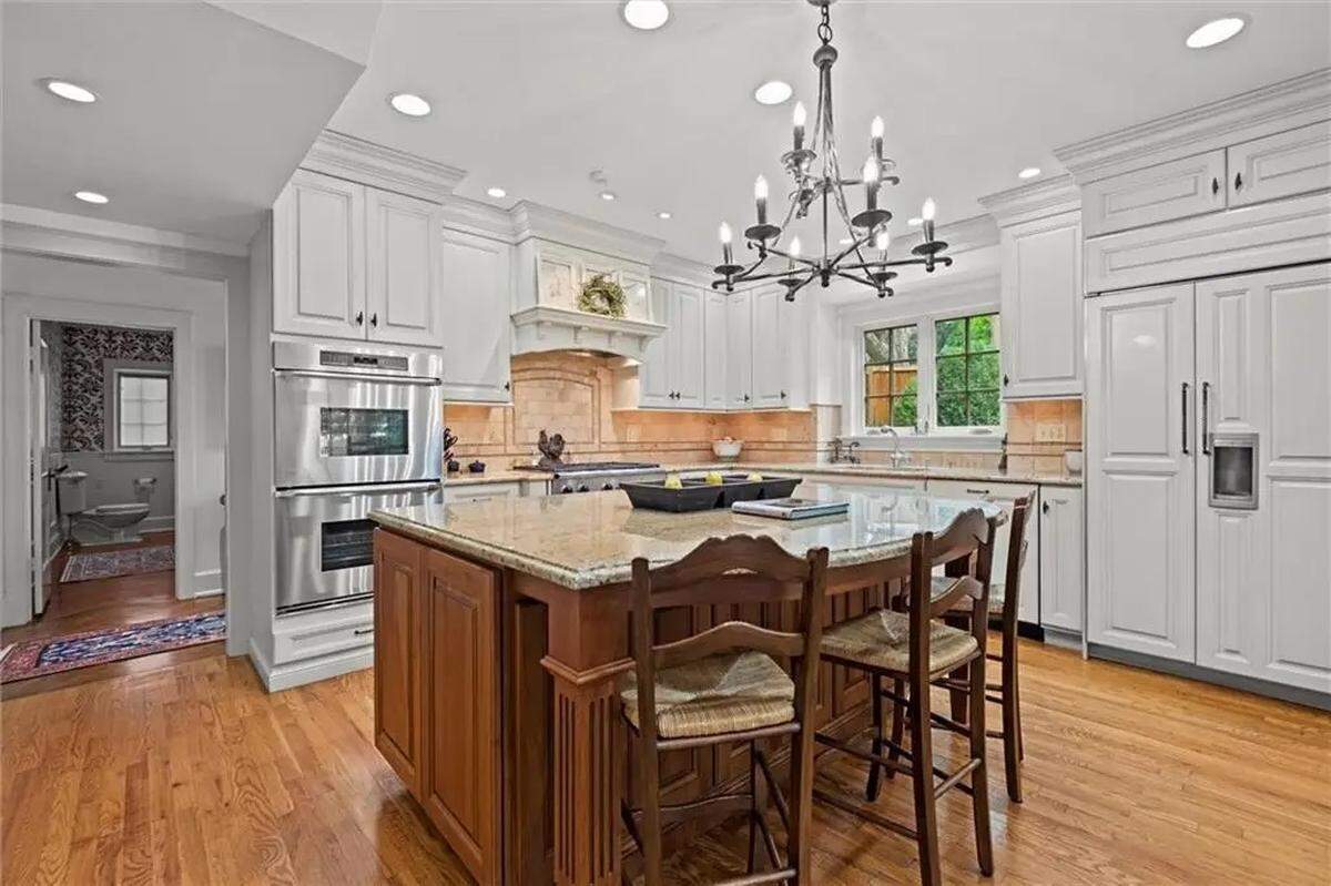 A refrigerator hides behind cabinet panels in the kitchen of a century-old home in Kansas City. 1234 W. 58th St. is located near Ward Parkway and Mission Hills.