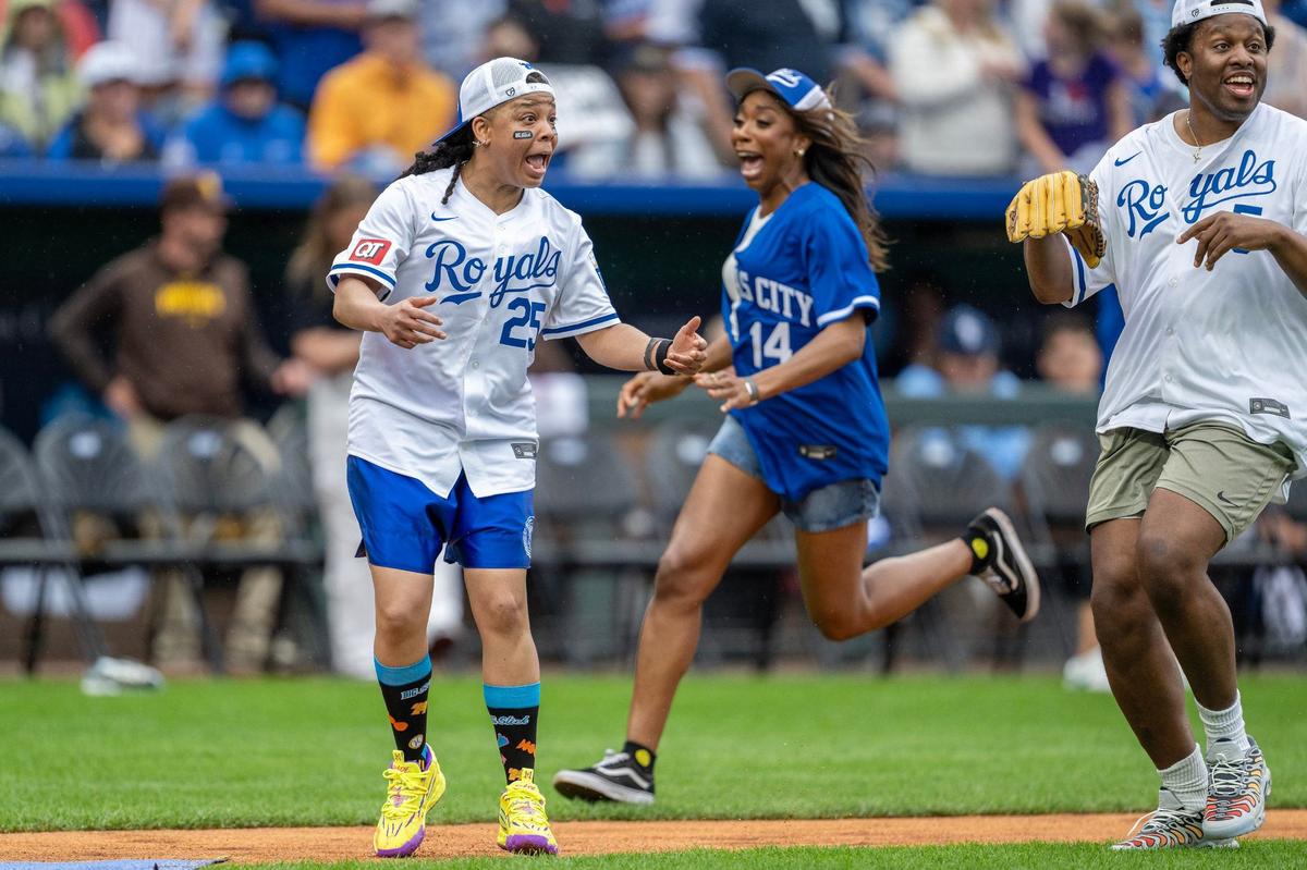 Actress Punkie Johnson, center, yells for the ball as actress Ego Nwodium runs to home plate during the Big Slick celebrity softball game at Kauffman Stadium on Friday, May 31, 2024, in Kansas City.