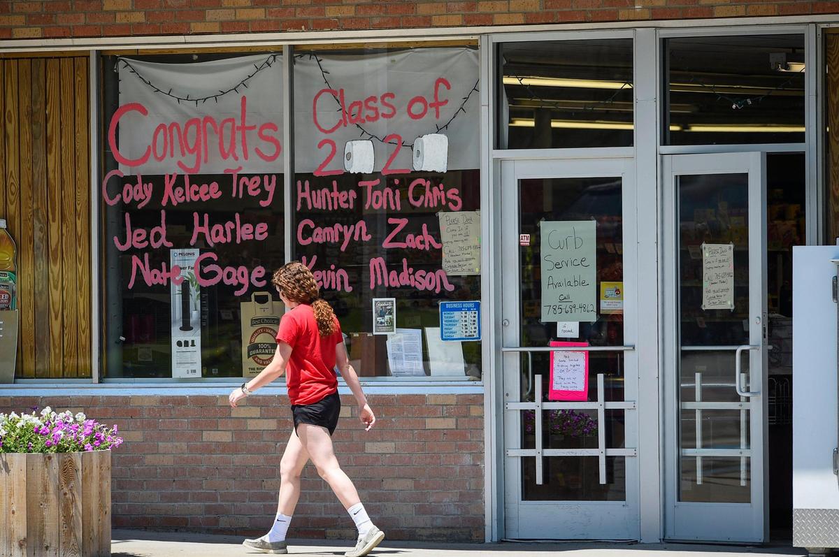 All 14 names of the Logan High School Class of 2020 are on the window of the Hometown Market grocery store in downtown Logan, Kansas. The northwest Kansas town of about 540 people has been hit hard by the COVID-19 pandemic. Four residents of the town’s nursing home have died.