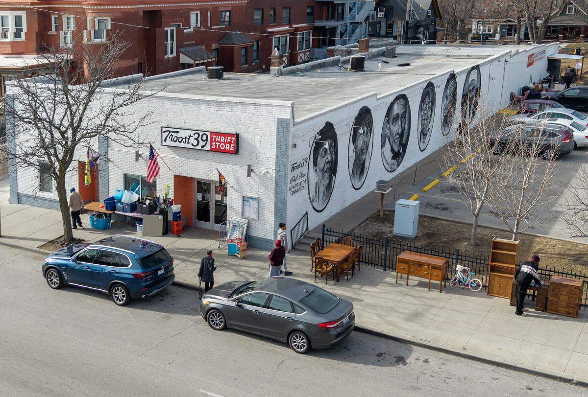 Customers look over furniture that sits on the sidewalk outside of Troost39, a popular thrift store at 3922 Troost Ave., on Thursday, Jan. 22 2026, in Kansas City.