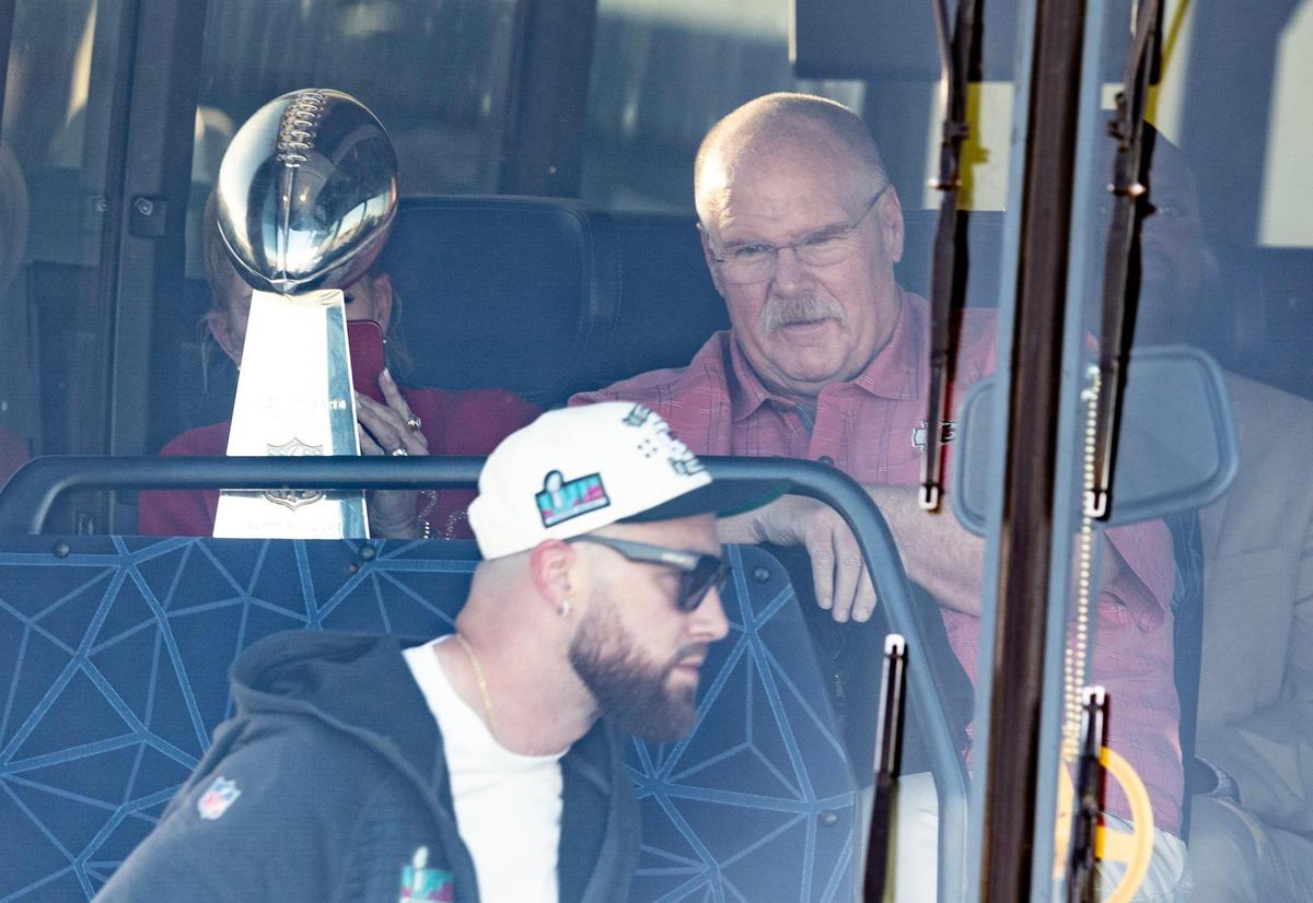 Chiefs coach Andy Reid watches as All-P)ro tight end Travis Kielce boards a charter bus after arriving at Kansas City International Airport on Monday. The Kansas City Chiefs returned home after defeating the Philadelphia Eagles in Super Bowl LVII in Glendale, Ariz.