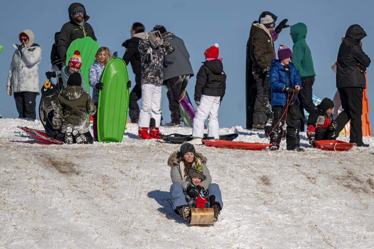 Sledders hit the slope at Meadowbrook Park on Sunday, Jan. 25, 2026 in Prairie Village. The frigid temperatures were no match for the crowd gathered to enjoy the aftermath of the weekend's winter storm.