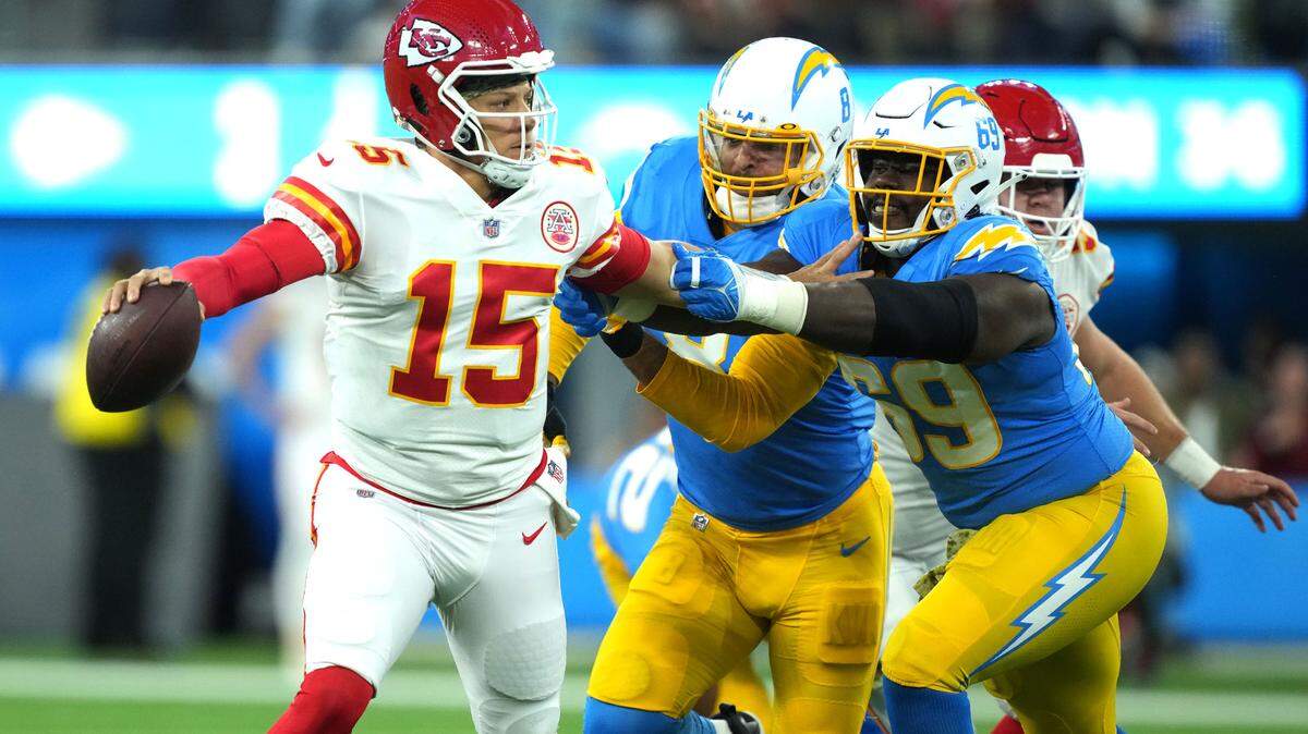 Kansas City Chiefs quarterback Patrick Mahomes (15) is pressured by Los Angeles Chargers linebacker Kyle Van Noy (8) and Los Angeles Chargers defensive tackle Sebastian Joseph-Day (69) in the first half at SoFi Stadium.