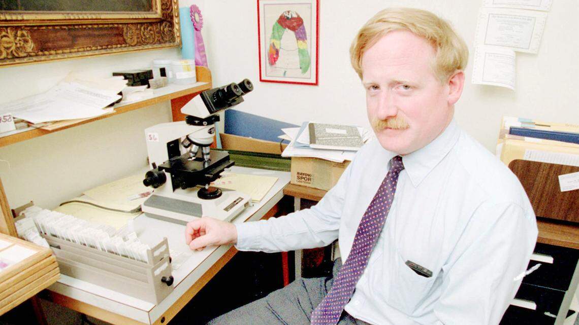 This is a file photo of Dr. Erik Mitchell at his desk in theMedical  Examiner’s office in Onondaga County on July 23, 1993. Photoby Dick Blume /  The Syracuse Newspapers.